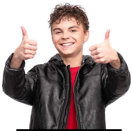 Tween boy wearing leather jacket and holding two thumbs up